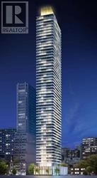 A tall building with a lit up top and the logo REALTOR on the top left.
