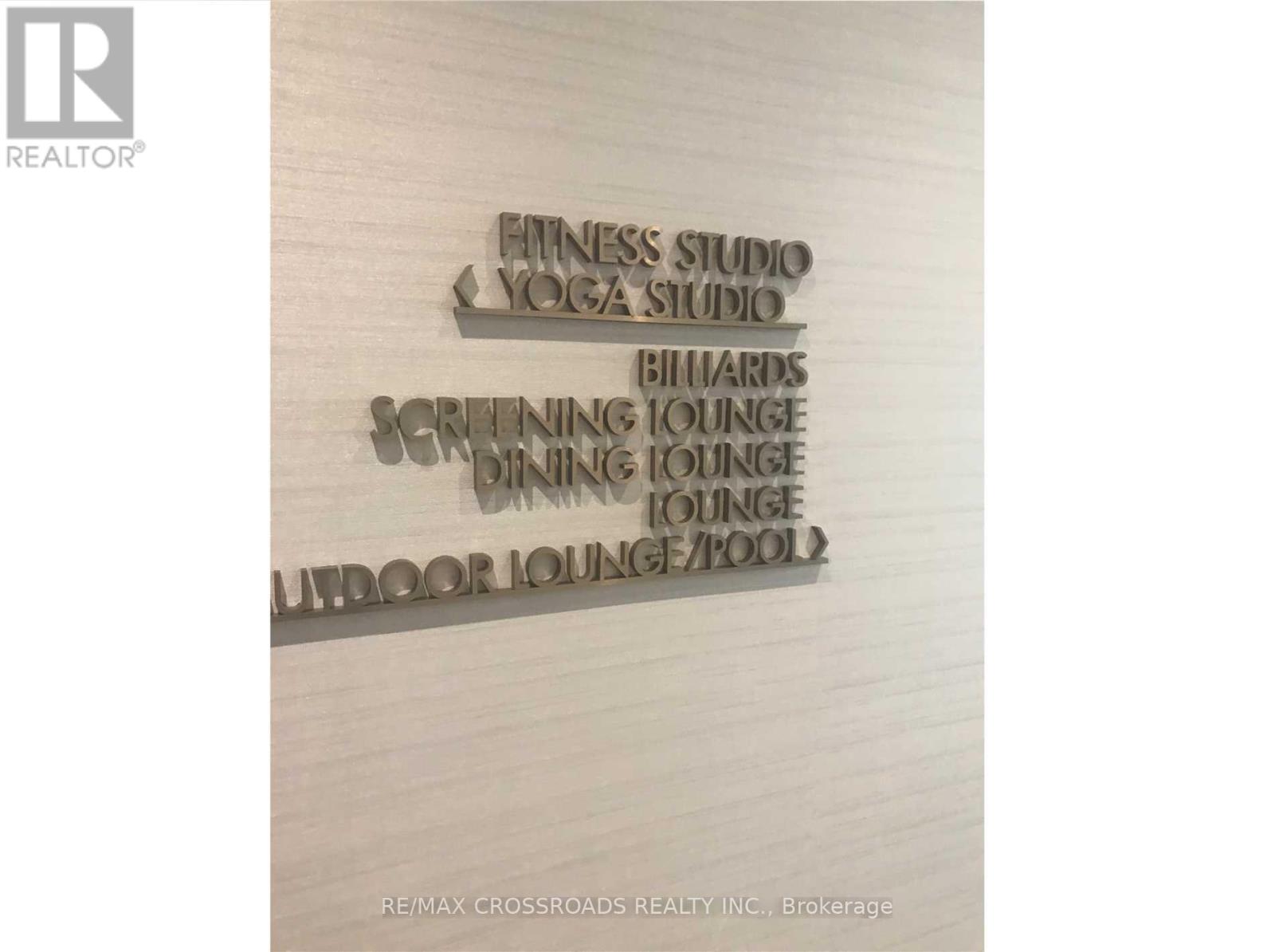 A sign lists amenities such as a fitness studio and an indoor pool.