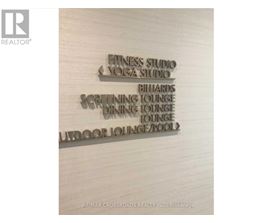 A sign lists amenities such as a fitness studio and an indoor pool.