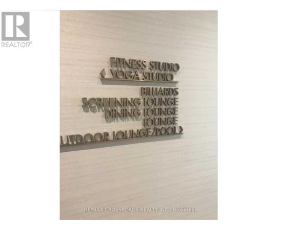 A sign lists amenities such as a fitness studio and an indoor pool.