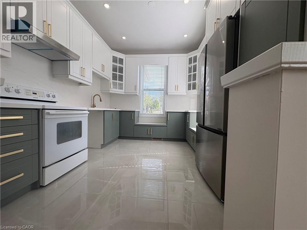 A modern kitchen with white cabinets and stainless steel appliances.