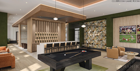 A pool table is in the middle of a room with a green wall and a sign that says "Clubroom Game Room".