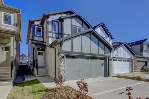 A modern house with a large garage door.