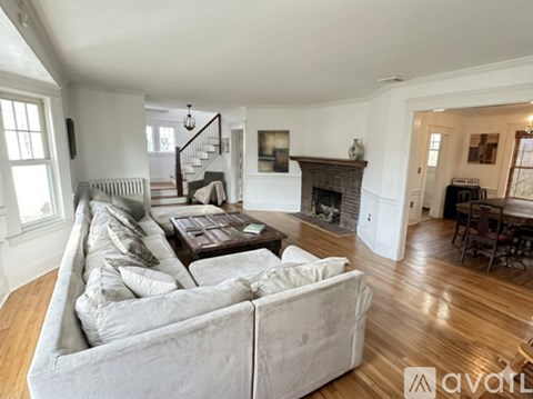 A living room with a large couch and a fireplace.
