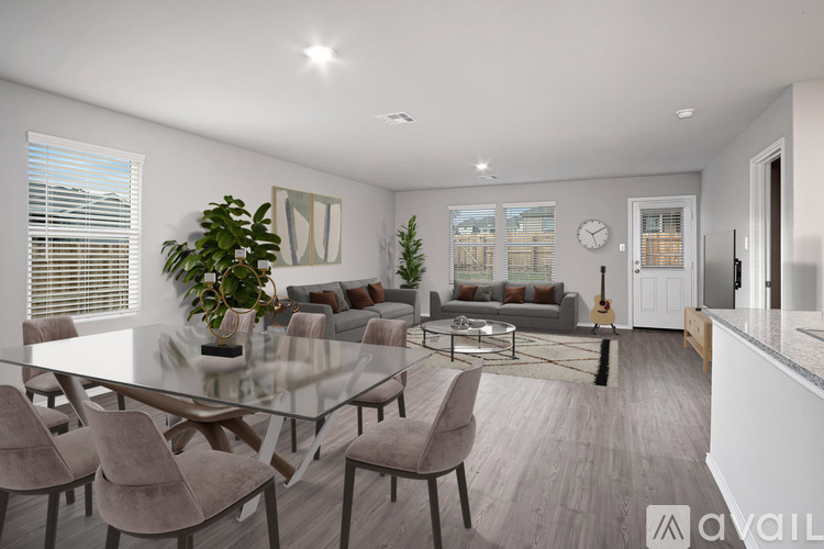 A modern dining room with a glass table and chairs.