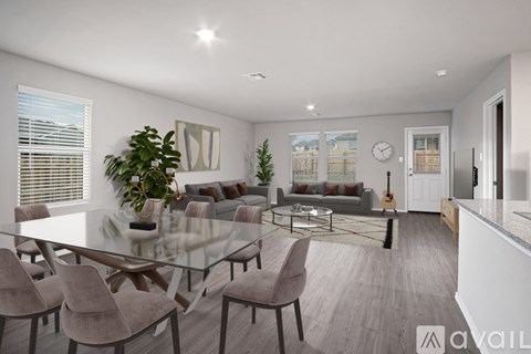 A modern dining room with a glass table and chairs.