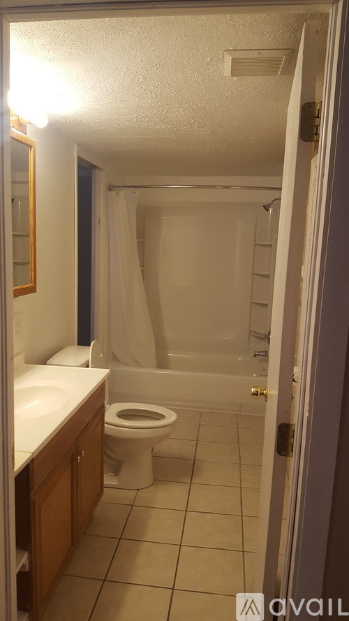 A bathroom with a toilet, sink, and bathtub.