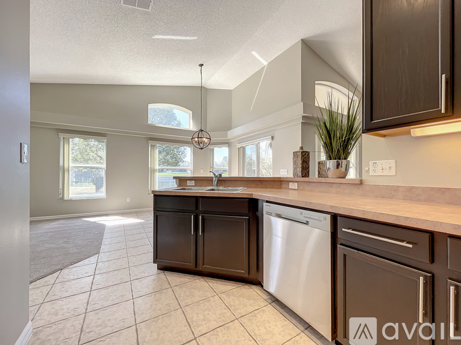 A kitchen with brown cabinets and a dishwasher.