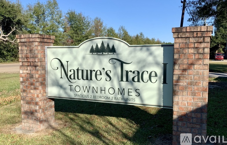A sign for Nature's Trace Townhomes with two bedrooms and two bathrooms.