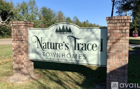 A sign for Nature's Trace Townhomes with two bedrooms and two bathrooms.