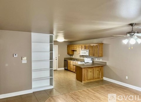A kitchen with wooden cabinets and a refrigerator with a white door.