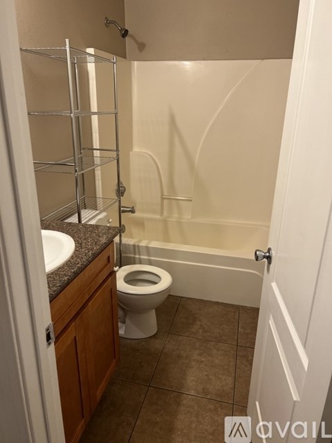 A bathroom with a toilet, sink, and bathtub.