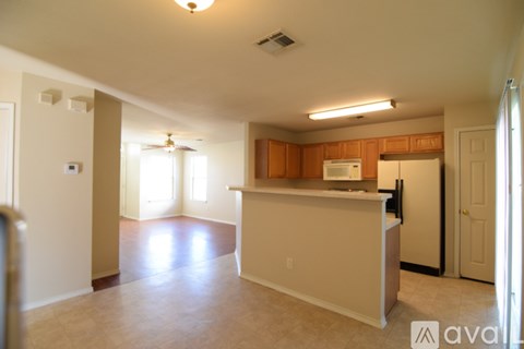 A kitchen area with a counter and a refrigerator.