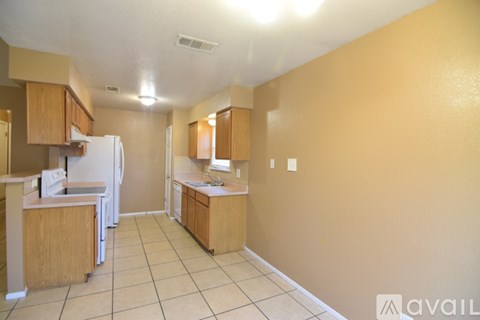 A kitchen with white appliances and wooden cabinets.