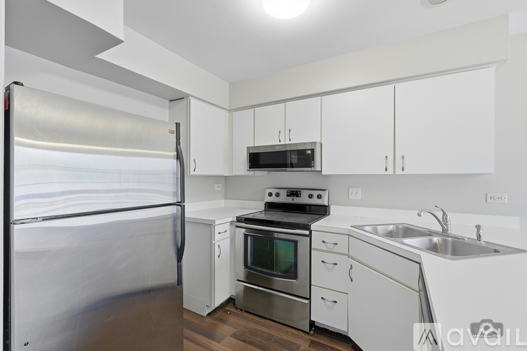 A kitchen with white cabinets and stainless steel appliances.