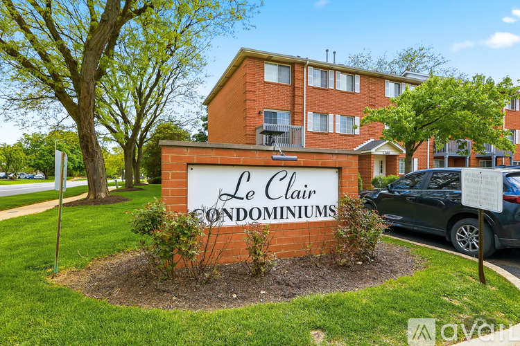 A brick building with a sign that says Le Clair Condominiums.