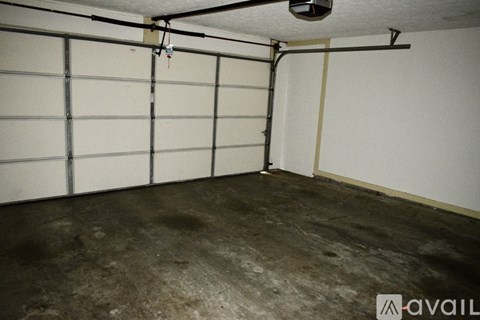 A spacious garage with a concrete floor and white walls.