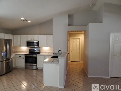 A kitchen with white cabinets and appliances.