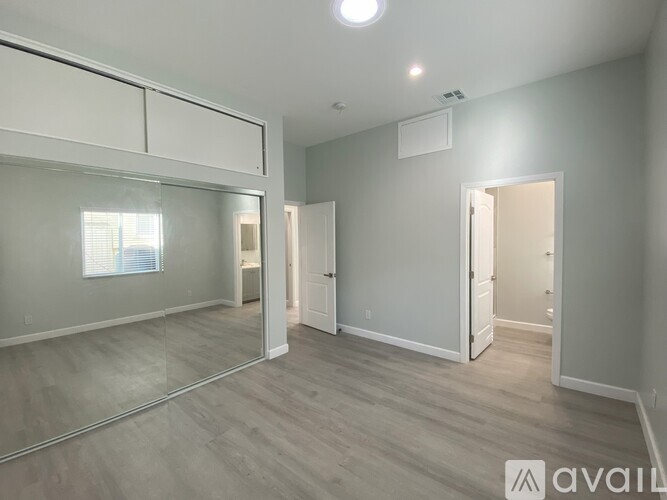 A spacious room with a sliding door and a window.