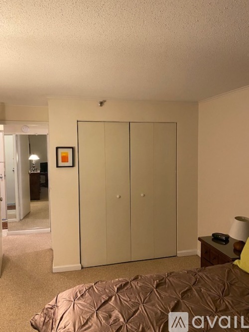 A bedroom with a bed, a dresser, and a mirror.