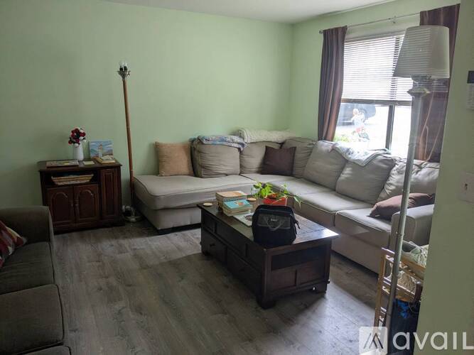 A living room with a couch, coffee table, and a lamp.