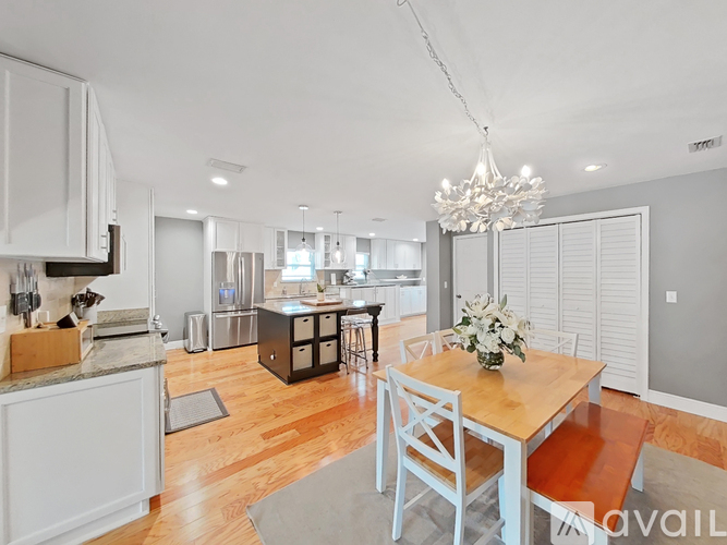 A modern kitchen with a dining table set up.