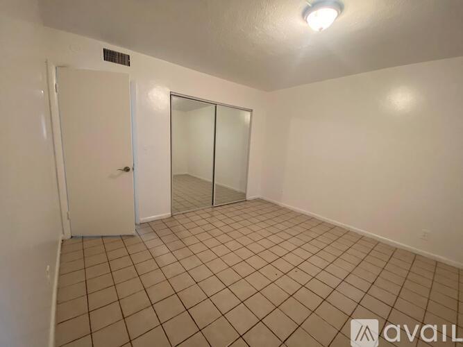 A room with a door and a glass door.