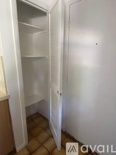 A white refrigerator with its door open in a kitchen.