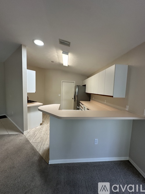 A kitchen with white cabinets and a countertop.