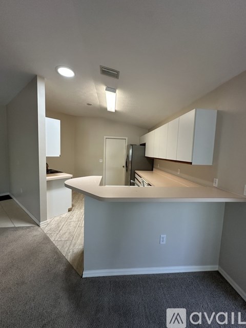 A kitchen with white cabinets and a countertop.