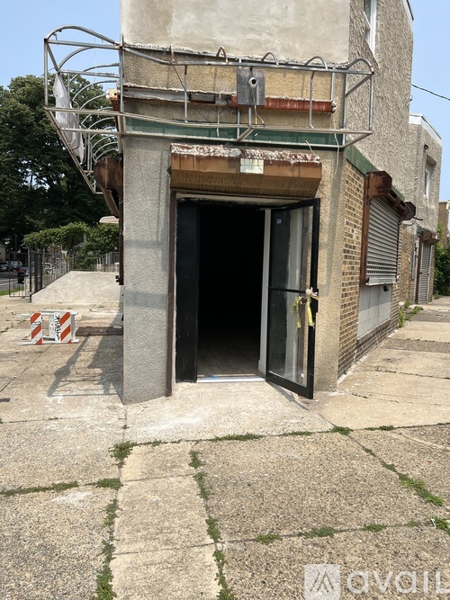 A concrete tunnel entrance with a metal railing on top.