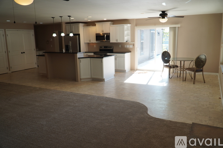 A kitchen with a dining table and chairs is available for rent.