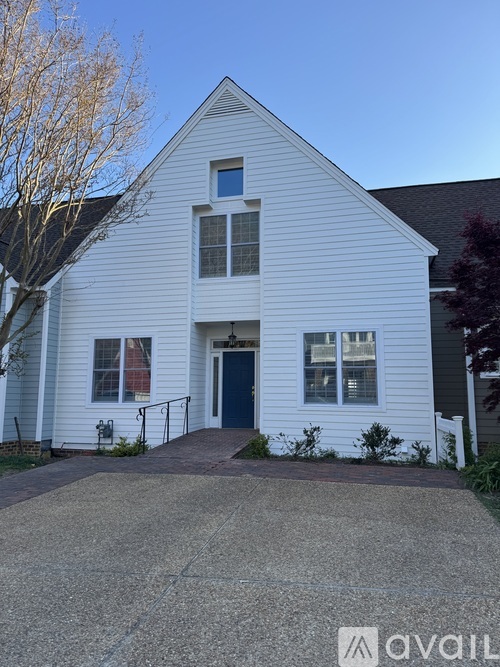 A white house with a black door and windows.