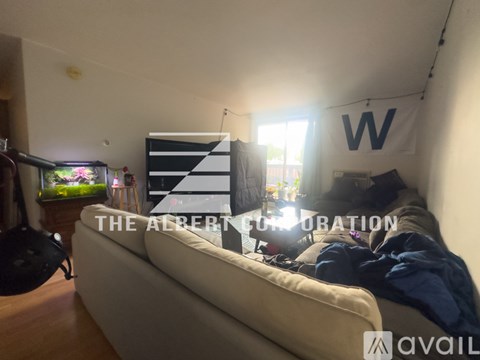 A living room with a white sofa and a fish tank.