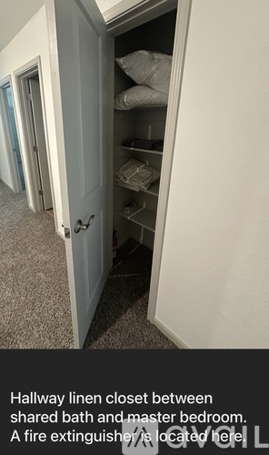 A hallway linen closet is shown between a shared bath and a master bedroom.