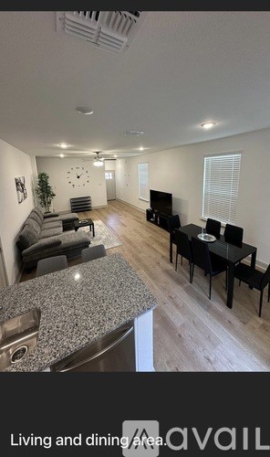 A living room with a dining table and chairs.