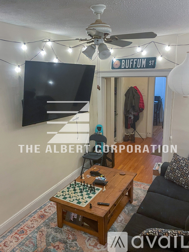 A living room with a chess board on the coffee table.