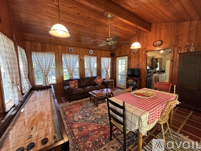 A room with a pool table and a couch.