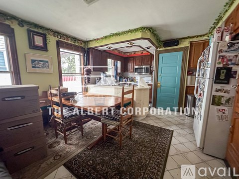A kitchen with a table and chairs in the middle of the room.