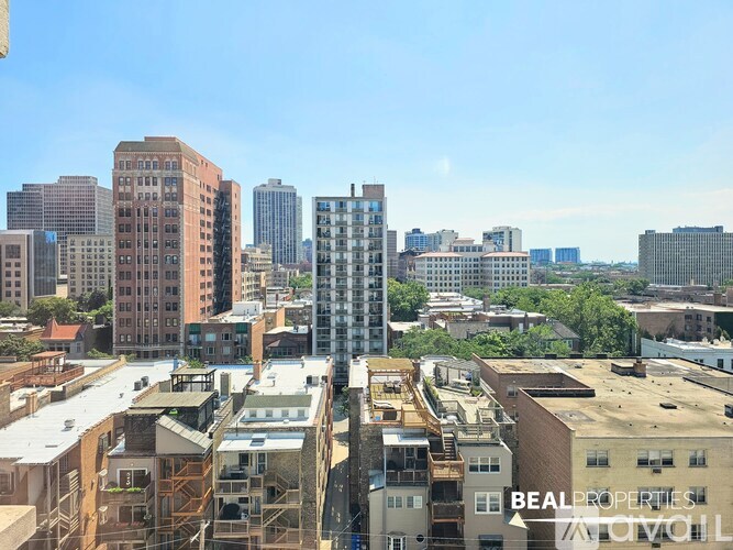 A cityscape with a mix of residential and commercial buildings, with a clear blue sky above.