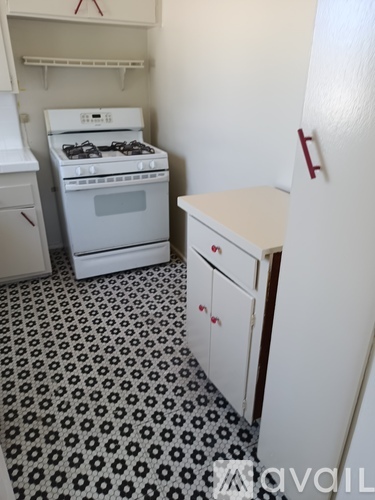 A kitchen with a black and white floor.