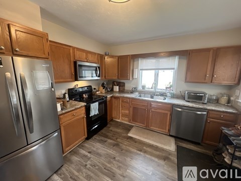 A kitchen with wooden cabinets and stainless steel appliances.