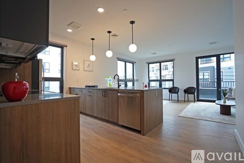 A kitchen with wooden cabinets and a red apple on the counter.