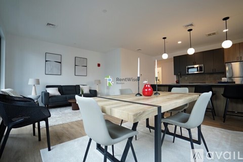 A modern dining room with a wooden table and chairs.