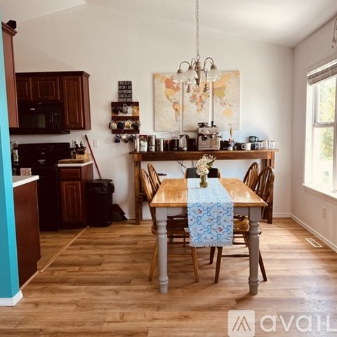 A kitchen with a table set for four.