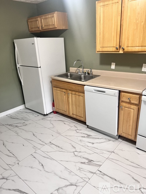 A kitchen with a white fridge and a white dishwasher.