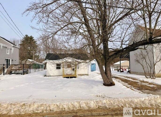 A house with a tree in front of it.