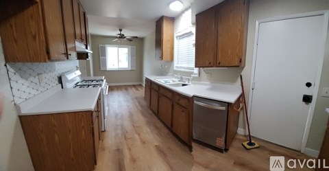 A kitchen with wooden cabinets and a white countertop.