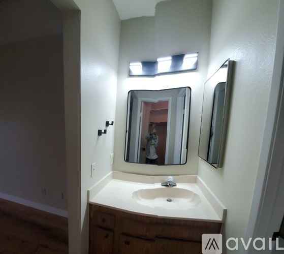 A bathroom with a sink and mirror.