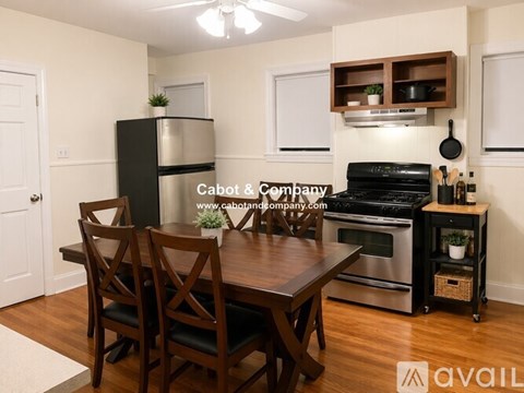 A kitchen with a table and chairs in the middle of the room.